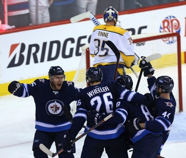 Paul Stastny, Blake Wheeler, Jacob Trouba and Josh Morrissey (from left) of the Winnipeg Jets celebrate a goal from Trouba against the Nashville Predators during Game 2 of their second-round playoff series in Winnipeg on Tues., May 1, 2018. Kevin King/Winnipeg Sun/Postmedia Network