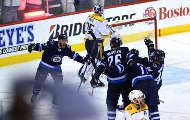 Paul Stastny, Blake Wheeler, Jacob Trouba and Josh Morrissey (from left) of the Winnipeg Jets celebrate a goal from Trouba against the Nashville Predators during Game 2 of their second-round playoff series in Winnipeg on Tues., May 1, 2018. Kevin King/Winnipeg Sun/Postmedia Network