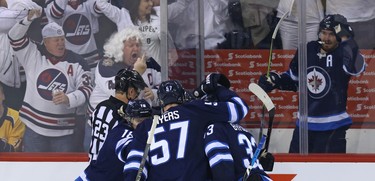 Winnipeg Jets centre Mark Scheifele (right) celebrates from the penalty box after Dustin Byfuglien scored against the Nashville Predators during Game 2 of their second-round playoff series in Winnipeg on Tues., May 1, 2018. Kevin King/Winnipeg Sun/Postmedia Network
