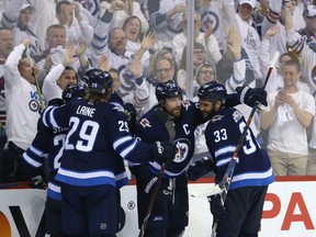 The Winnipeg Jets celebrate the game-winning goal from Blake Wheeler (centre) against the Nashville Predators during Game 2 of their second-round playoff series in Winnipeg on Tues., May 1, 2018. Kevin King/Winnipeg Sun/Postmedia Network