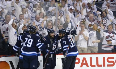 The Winnipeg Jets celebrate the game-winning goal from Blake Wheeler (centre) against the Nashville Predators during Game 2 of their second-round playoff series in Winnipeg on Tues., May 1, 2018. Kevin King/Winnipeg Sun/Postmedia Network