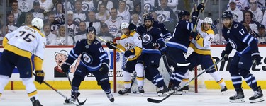 Winnipeg Jets defenceman Josh Morrissey (centre left) blocks Nashville Predators forward Craig Smith while defence partner Jacob Trouba (centre right) ties up Viktor Arvidsson during a power-play in Game 2 of their second-round playoff series in Winnipeg on Tues., May 1, 2018. Kevin King/Winnipeg Sun/Postmedia Network