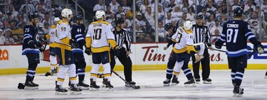 Players watch as Winnipeg Jets defenceman Jacob Trouba scraps with Nashville Predators centre Nick Bonino during Game 2 of their second-round playoff series in Winnipeg on Tues., May 1, 2018. Kevin King/Winnipeg Sun/Postmedia Network
