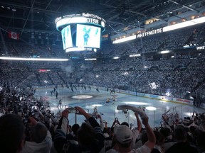 Fans cheer as the Winnipeg Jets step on the ice