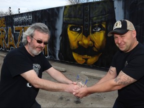 Stone Angel Brewing co-owner Paul Clerkin (left) and Brazen Hall co-owner Kris Kopansky each maintain a hold on the Schlitz Light Cup outside of Brazen Hall in Winnipeg on Thurs., May 3, 2018. The two breweries will introduce a collaborative beer before engaging in a tug-of-war for the trophy on Sunday. Kevin King/Winnipeg Sun/Postmedia Network