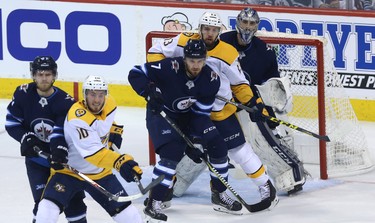 Winnipeg Jets defenceman Ben Chiarot (left) defends Nashville Predators centre Nick Bonino in front of goaltender Connor Hellebuyck during Game 4 of their second-round NHL playoff series in Winnipeg on Thurs., May 3, 2018. Kevin King/Winnipeg Sun/Postmedia Network