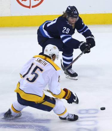 Winnipeg Jets forward Patrik Laine (top) backhands a pass past Nashville Predators forward Craig Smith during Game 4 of their second-round NHL playoff series in Winnipeg on Thurs., May 3, 2018. Kevin King/Winnipeg Sun/Postmedia Network