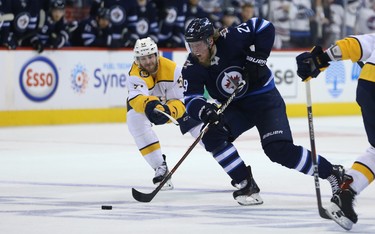 Winnipeg Jets forward Patrik Laine cuts past Nashville Predators forward Austin Watson during Game 4 of their second-round NHL playoff series in Winnipeg on Thurs., May 3, 2018. Kevin King/Winnipeg Sun/Postmedia Network