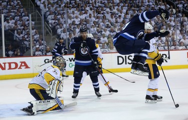 Winnipeg Jets Nikolaj Ehlers (right) jumps to avoid a shot in front of Nashville Predators goaltender Pekka Rinne during Game 4 of their second-round NHL playoff series in Winnipeg on Thurs., May 3, 2018. Kevin King/Winnipeg Sun/Postmedia Network