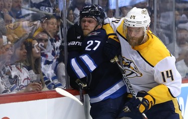 Winnipeg Jets forward Nikolaj Ehlers (left) is rubbed out by Nashville Predators defenceman Mattias Ekholm during Game 4 of their second-round NHL playoff series in Winnipeg on Thurs., May 3, 2018. Kevin King/Winnipeg Sun/Postmedia Network