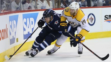 Winnipeg Jets forward Nikolaj Ehlers (left) and Nashville Predators defenceman Mattias Ekholm battle during Game 4 of their second-round NHL playoff series in Winnipeg on Thurs., May 3, 2018. Kevin King/Winnipeg Sun/Postmedia Network