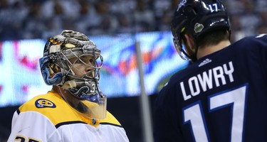 Nashville Predators goaltender Pekka Rinne and Winnipeg Jets centre Adam Lowry lock eyes during Game 4 of their second-round NHL playoff series in Winnipeg on Thurs., May 3, 2018. Kevin King/Winnipeg Sun/Postmedia Network