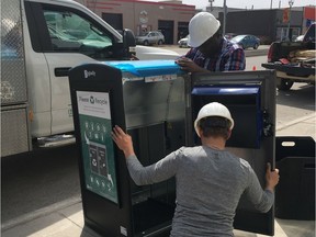 Workers put the finishing touches on Transcona's new Big Belly Solar Compactor.
