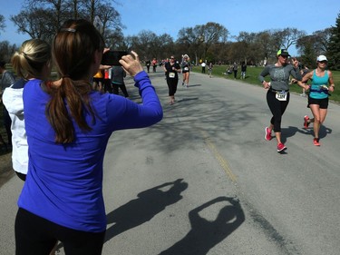 A woman snaps a picture during the Winnipeg Police Service half marathon in Assiniboine Park in Winnipeg on Sun., May 6, 2018. Kevin King/Winnipeg Sun/Postmedia Network