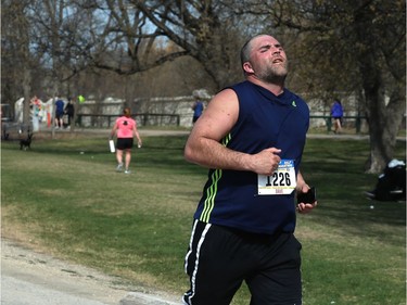 A participant digs deep as he runs through Assiniboine Park during the Winnipeg Police Service half marathon in Winnipeg on Sun., May 6, 2018. Kevin King/Winnipeg Sun/Postmedia Network