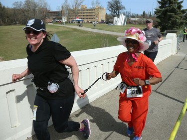 An inmate is dragged across the Assiniboine Park foot bridge during the Winnipeg Police Service half marathon in Winnipeg on Sun., May 6, 2018. Kevin King/Winnipeg Sun/Postmedia Network