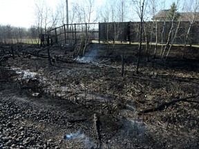 Areas smoulder near the Shaftesbury Park Retirement Residence from what police called a brush fire near the intersection of Sterling Lyon Parkway and Shaftesbury Boulevard in Winnipeg on Sun., May 6, 2018. People were asked to leave the Assiniboine Forest and Sterling Lyon was closed westbound at Shaftesbury while the Winnipeg Police Service and Winnipeg Fire Paramedic Services dealt with it, police said. Kevin King/Winnipeg Sun/Postmedia Network