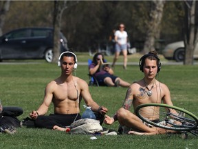 Dudes chill at Assiniboine Park on a sunny day on Monday.