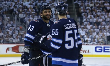 Winnipeg Jets defenceman Dustin Byfuglien (left) and centre Mark Scheifele have a discussion in the Nashville Predators zone prior to a face-off during Game 6 of their NHL playoff series in Winnipeg on Mon., May 7, 2018. Kevin King/Winnipeg Sun/Postmedia Network