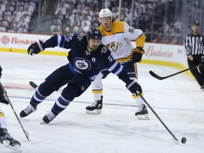 Winnipeg Jets centre Mark Scheifele (centre) loses control of the puck in the Nashville Predators zone during Game 6 of their NHL playoff series in Winnipeg on Mon., May 7, 2018. Kevin King/Winnipeg Sun/Postmedia Network