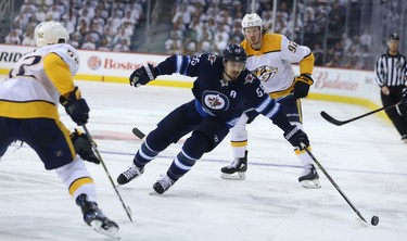 Winnipeg Jets centre Mark Scheifele (centre) loses control of the puck in the Nashville Predators zone during Game 6 of their NHL playoff series in Winnipeg on Mon., May 7, 2018. Kevin King/Winnipeg Sun/Postmedia Network