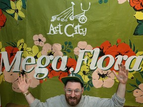 Eddie Ayoub, artistic director at Art City, poses with the banner for its fundraising event Saturday, at its studio on Broadway in Winnipeg on Wed., May 9, 2018. Kevin King/Winnipeg Sun/Postmedia Network