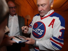Barry Shenkarow (left) stands beside former Winnipeg Jet Anders Hedberg while he signs a book at the 1978 Winnipeg Jets reunion, in Winnipeg.  Saturday, May 12, 2018.   Sun/Postmedia Network