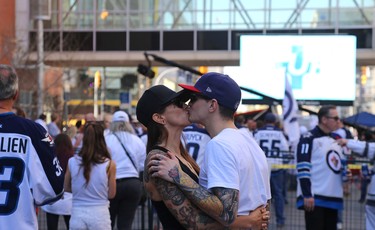 A couple shares a moment during the Whiteout Street Party prior to the Winnipeg Jets facing the Vegas Golden Knights in Game 1 of their Western Conference final series in Winnipeg on Sat., May 12, 2018. Kevin King/Winnipeg Sun/Postmedia Network