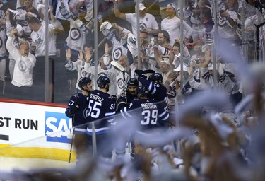 Winnipeg Jets defenceman Dustin Byfuglien is congratulated on his goal against the Vegas Golden Knights during Game 1 of their Western Conference final series in Winnipeg on Sat., May 12, 2018. Kevin King/Winnipeg Sun/Postmedia Network