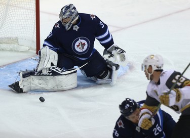 Winnipeg Jets goaltender Connor Hellebuyck makes a save against the Vegas Golden Knights during Game 1 of their Western Conference final series in Winnipeg on Sat., May 12, 2018. Kevin King/Winnipeg Sun/Postmedia Network