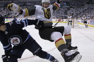 Vegas Golden Knights defenceman Colin Miller (right) is upended by Winnipeg Jets forward Brandon Tanev during Game 1 of their Western Conference final series in Winnipeg on Sat., May 12, 2018. Kevin King/Winnipeg Sun/Postmedia Network