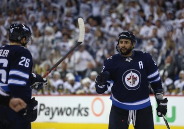 Winnipeg Jets defenceman Dustin Byfuglien (right) and Blake Wheeler celebrate a power-play goal from Mark Scheifele (not shown) against the Vegas Golden Knights during Game 1 of their Western Conference final series in Winnipeg on Sat., May 12, 2018. Kevin King/Winnipeg Sun/Postmedia Network