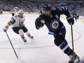 Winnipeg Jets centre Mark Scheifele (right) tries to spin away from the checking of Vegas Golden Knights defenceman Nate Schmidt during Game 1 of their Western Conference final series in Winnipeg on Sat., May 12, 2018. Kevin King/Winnipeg Sun/Postmedia Network