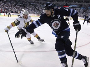 Winnipeg Jets centre Mark Scheifele (right) tries to spin away from the checking of Vegas Golden Knights defenceman Nate Schmidt during Game 1 of their Western Conference final series in Winnipeg on Sat., May 12, 2018. (Kevin King/Postmedia Network)