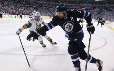 Winnipeg Jets centre Mark Scheifele (right) tries to spin away from the checking of Vegas Golden Knights defenceman Nate Schmidt during Game 1 of their Western Conference final series in Winnipeg on Sat., May 12, 2018. Kevin King/Winnipeg Sun/Postmedia Network