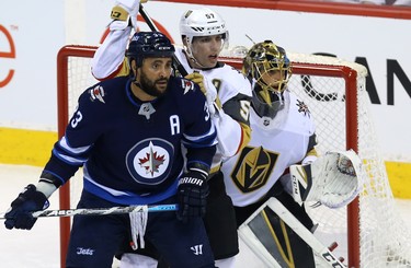 Winnipeg Jets defenceman Dustin Byfuglien (left) sets up in front of Vegas Golden Knights goaltender Marc-Andre Fleury (right) as forward David Perron defends during Game 1 of their Western Conference final series in Winnipeg on Sat., May 12, 2018. Kevin King/Winnipeg Sun/Postmedia Network