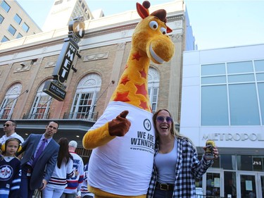 Rebecca Martin and a very tall friend meet at the Whiteout Street Party before the Winnipeg Jets faced the Vegas Golden Knights in Game 2 of the Western Conference final in Winnipeg on Mon., May 14, 2018. Kevin King/Winnipeg Sun/Postmedia Network