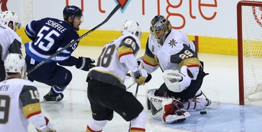 Winnipeg Jets centre Mark Scheifele (left) gets the puck through Vegas Golden Knights goaltender Marc-Andre Fleury but not in the net during Game 2 of the Western Conference final in Winnipeg on Mon., May 14, 2018. Kevin King/Winnipeg Sun/Postmedia Network