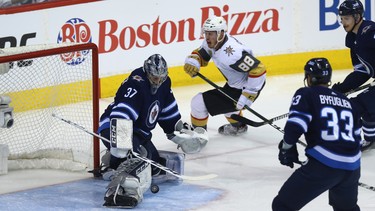 Winnipeg Jets goaltender Connor Hellebuyck makes a save on Vegas Golden Knights defenceman Nate Schmidt during Game 2 of the Western Conference final in Winnipeg on Mon., May 14, 2018. Kevin King/Winnipeg Sun/Postmedia Network