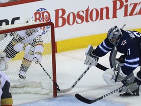 Winnipeg Jets goaltender Connor Hellebuyck can't keep Vegas Golden Knights forward Tomas Tatar from tucking the puck in the net during Game 2 of the Western Conference final in Winnipeg on Mon., May 14, 2018. Kevin King/Winnipeg Sun/Postmedia Network