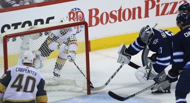 Winnipeg Jets goaltender Connor Hellebuyck can't keep Vegas Golden Knights forward Tomas Tatar from tucking the puck in the net during Game 2 of the Western Conference final in Winnipeg on Mon., May 14, 2018. Kevin King/Winnipeg Sun/Postmedia Network