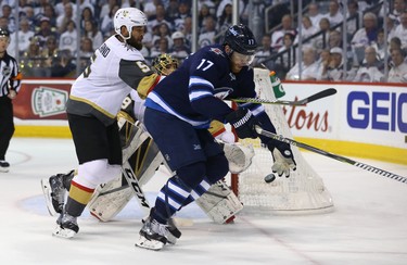 Winnipeg Jets centre Adam Lowry gloves down a puck in front of Vegas Golden Knights defenceman Deryk Engelland during Game 2 of the Western Conference final in Winnipeg on Mon., May 14, 2018. Kevin King/Winnipeg Sun/Postmedia Network