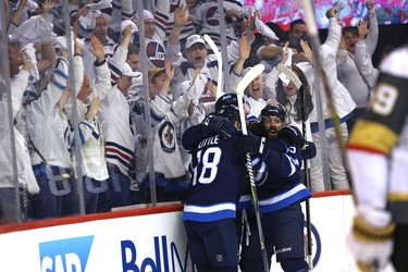 Winnipeg Jets forward Mathieu Perreault (right) celebrates with Kyle Connor and Bryan Little after Connor's goal against the Vegas Golden Knights during Game 2 of the Western Conference final in Winnipeg on Mon., May 14, 2018. Kevin King/Winnipeg Sun/Postmedia Network