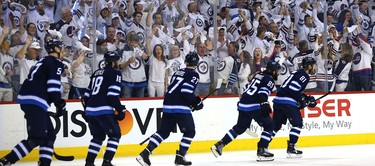 Fans celebrate as the Winnipeg Jets skate off after a goal from Kyle Connor against the Vegas Golden Knights during Game 2 of the Western Conference final in Winnipeg on Mon., May 14, 2018. Kevin King/Winnipeg Sun/Postmedia Network