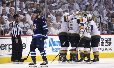 Winnipeg Jets centre Adam Lowry skates past as the Vegas Golden Knights celebrate a goal from Jonathan Marchessault during Game 2 of the Western Conference final in Winnipeg on Mon., May 14, 2018. Kevin King/Winnipeg Sun/Postmedia Network