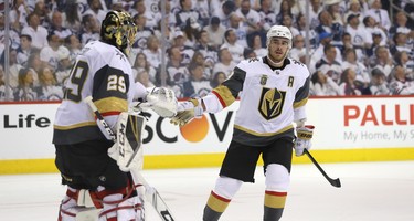 Vegas Golden Knights forward Reilly Smith celebrates with goaltender Marc-Andre Fleury after Vegas's third goal during the third period of Game 2 of the Western Conference final in Winnipeg on Mon., May 14, 2018. Kevin King/Winnipeg Sun/Postmedia Network