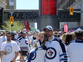 Fans pose for a selfie at the goal light at the Whiteout Street Party before the Winnipeg Jets battled the Vegas Golden Knights during Game 5 of the Western Conference final in Winnipeg on Sunday.
