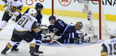 A shot from Winnipeg Jets centre Bryan Little doesn't get to the net as forward Jack Roslovic lies on top of Vegas Golden Knights goaltender Marc-Andre Fleury during Game 5 of the Western Conference final in Winnipeg on Sun., May 20, 2018. Kevin King/Winnipeg Sun/Postmedia Network