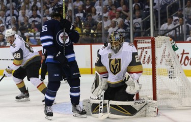 Vegas Golden Knights goaltender Marc-Andre Fleury makes a save with his eyes closed as Winnipeg Jets forward Mathieu Perreault provides a screen during Game 5 of the Western Conference final in Winnipeg on Sun., May 20, 2018. Kevin King/Winnipeg Sun/Postmedia Network