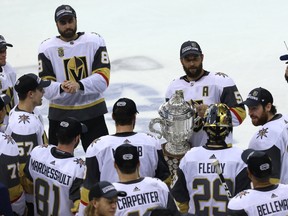Vegas Golden Knights alternate captain Deryk Engelland brings the Clarence Campbell Bowl to goaltender Marc-Andre Fleury after they knocked off the Winnipeg Jets in the Western Conference final in Winnipeg on Sun., May 20, 2018. Kevin King/Winnipeg Sun/Postmedia Network